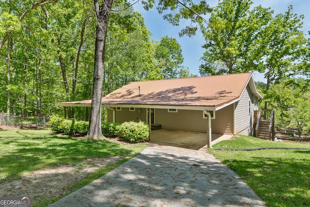 single story home featuring concrete driveway, an attached carport, metal roof, and a front lawn