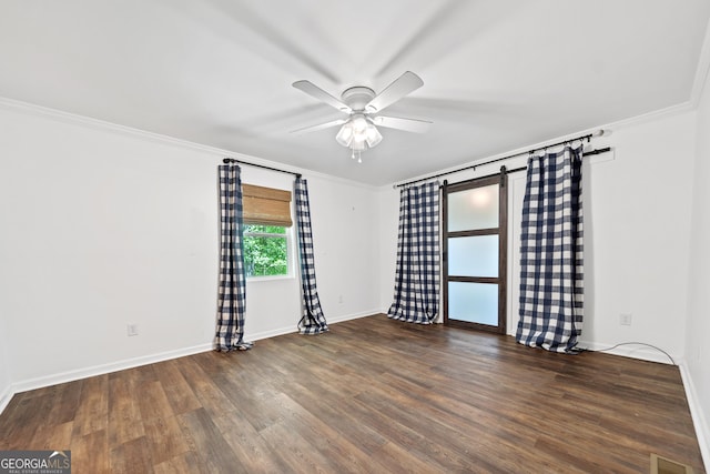 unfurnished room with crown molding, a ceiling fan, baseboards, and wood finished floors