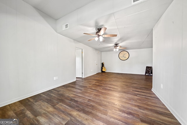 spare room with ceiling fan, wood finished floors, and visible vents