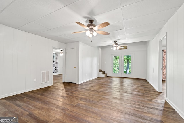 unfurnished living room with a ceiling fan, baseboards, visible vents, and wood finished floors