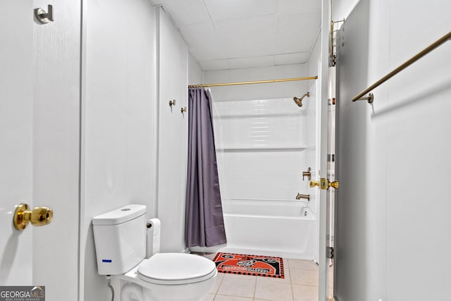 bathroom with tile patterned floors, shower / bathtub combination with curtain, toilet, and a paneled ceiling