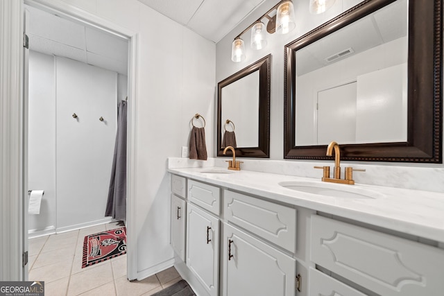 full bathroom featuring a sink, tile patterned floors, double vanity, and visible vents