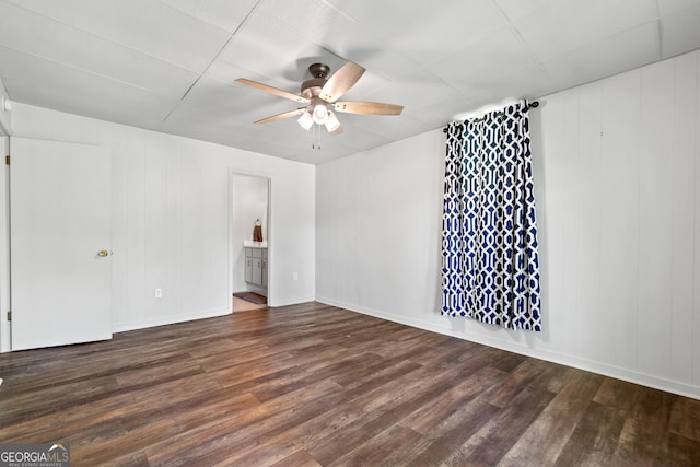 unfurnished room with baseboards, ceiling fan, and wood finished floors