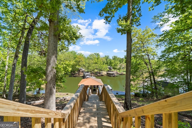 view of dock with a gazebo and a water view