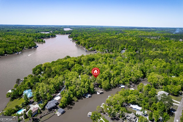 aerial view with a forest view and a water view