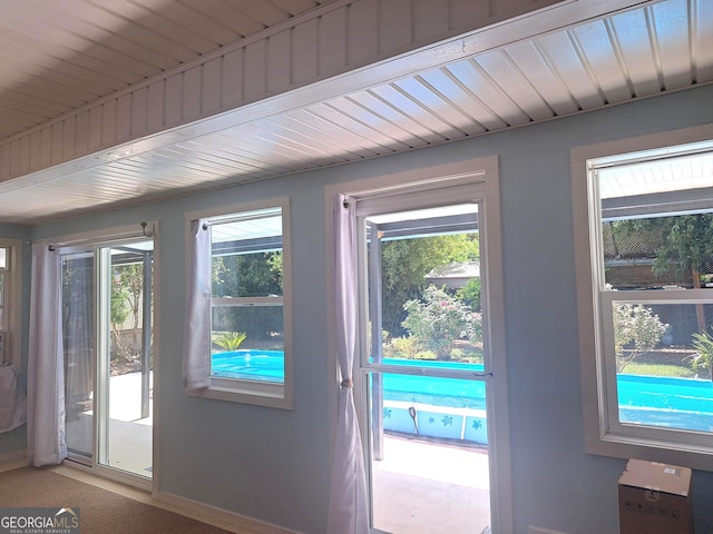 doorway with a healthy amount of sunlight and baseboards