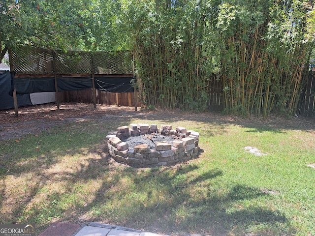 view of yard with a fire pit