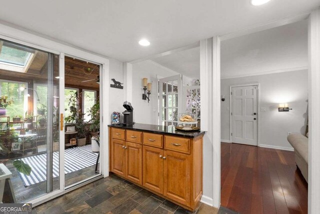 bar featuring recessed lighting, a skylight, and baseboards