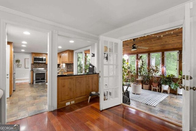 interior space with crown molding, ceiling fan, french doors, recessed lighting, and dark wood-style floors