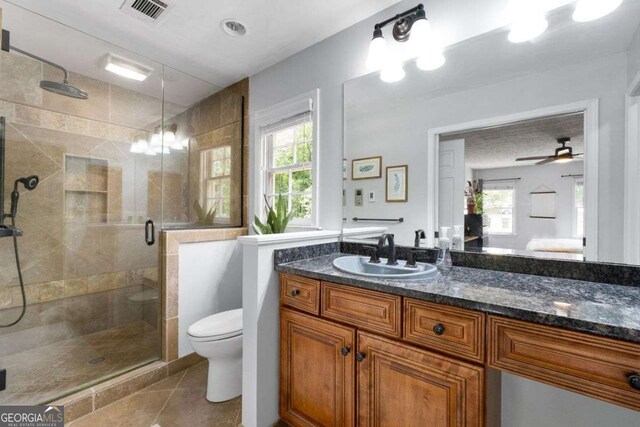 bathroom with visible vents, a shower stall, vanity, tile patterned floors, and toilet