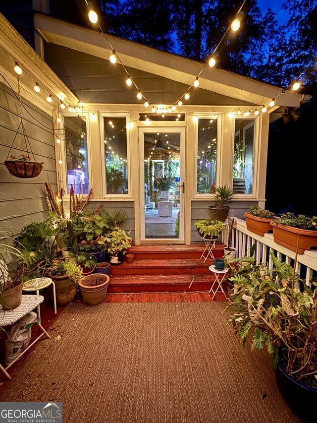view of exterior entry at night