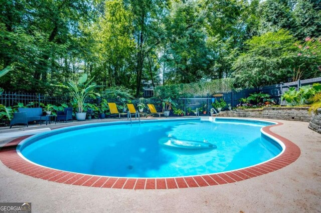 view of swimming pool with a fenced in pool and a fenced backyard