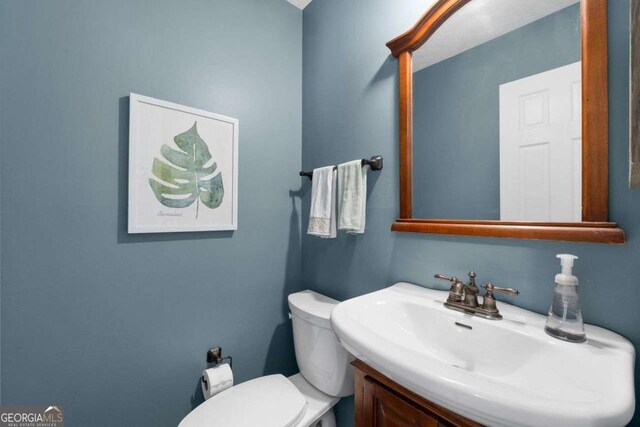 bathroom featuring toilet and a sink