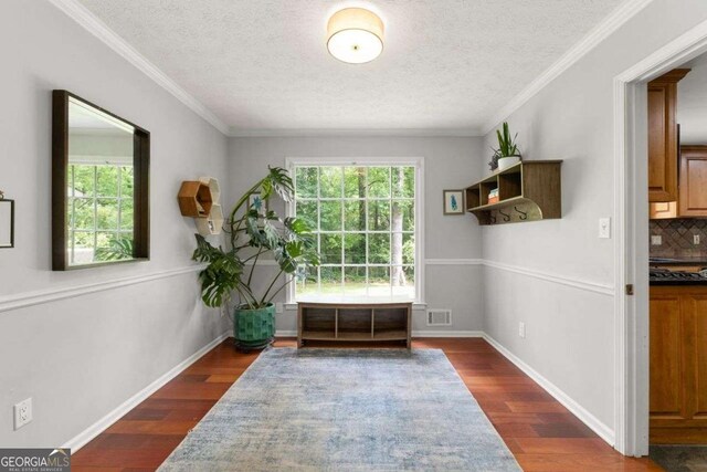 doorway to outside featuring visible vents, crown molding, a textured ceiling, and dark wood-style flooring