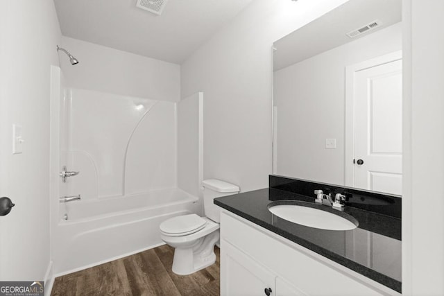 3261 Broadnax Mill Rd Unit 2, Loganville, GA 30052 - bathroom with visible vents, vanity, wood finished floors, toilet, and shower / tub combination