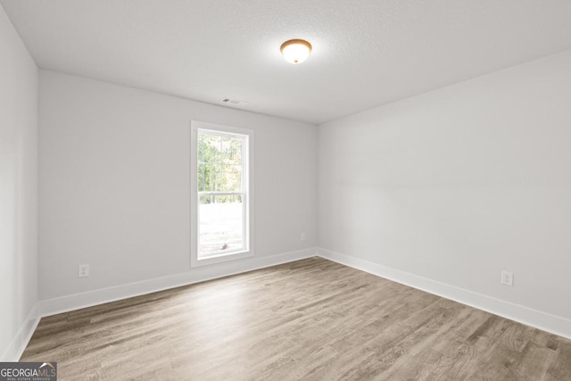 3261 Broadnax Mill Rd Unit 2, Loganville, GA 30052 - unfurnished room with baseboards, visible vents, and wood finished floors