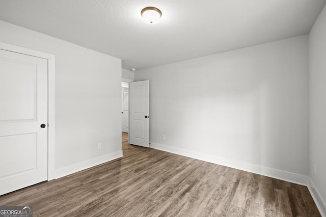 3261 Broadnax Mill Rd Unit 2, Loganville, GA 30052 - unfurnished bedroom featuring baseboards and wood finished floors