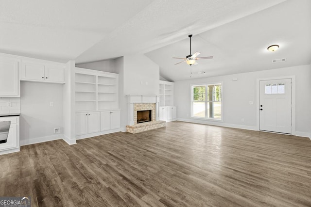3261 Broadnax Mill Rd Unit 2, Loganville, GA 30052 - unfurnished living room with a brick fireplace, ceiling fan, wood finished floors, and lofted ceiling