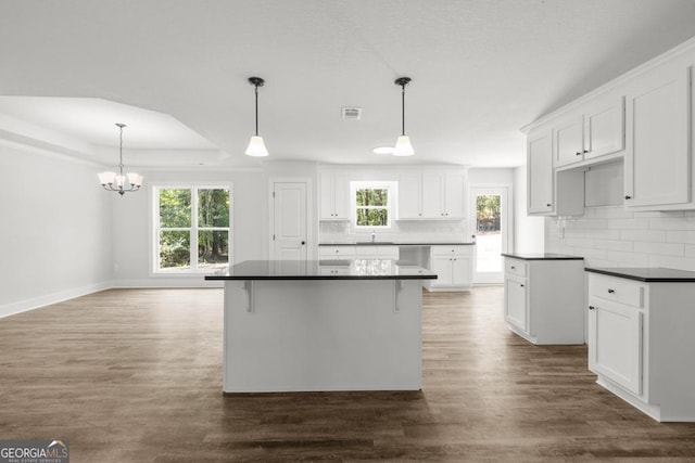 3261 Broadnax Mill Rd Unit 2, Loganville, GA 30052 - kitchen featuring visible vents, dark countertops, a sink, dark wood finished floors, and backsplash