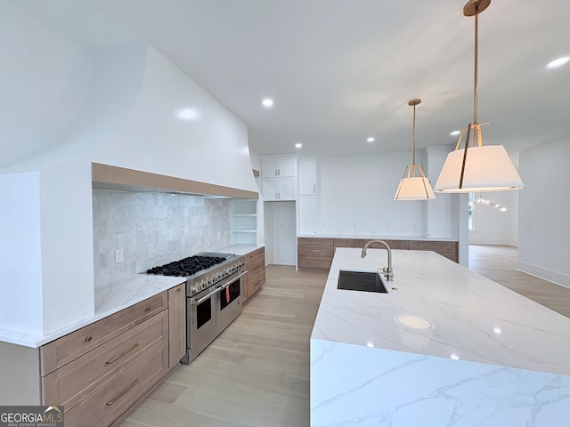 5753 Brendlynn Dr, Suwanee, GA 30024 - kitchen featuring range with two ovens, a spacious island, light stone counters, recessed lighting, and backsplash