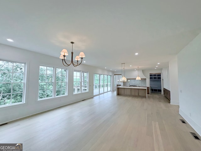 5753 Brendlynn Dr, Suwanee, GA 30024 - unfurnished living room with a chandelier, recessed lighting, and light wood-style floors