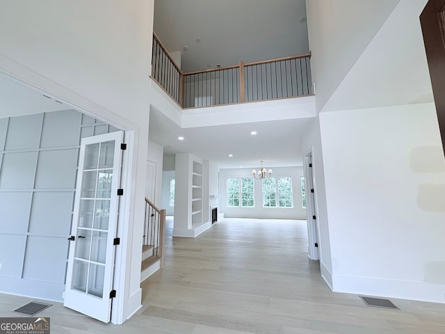 5753 Brendlynn Dr, Suwanee, GA 30024 - foyer entrance featuring a chandelier, stairs, light wood-type flooring, a high ceiling, and recessed lighting