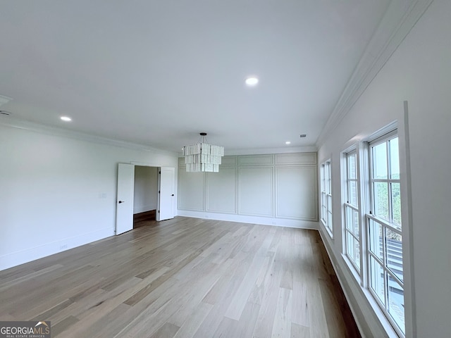 5753 Brendlynn Dr, Suwanee, GA 30024 - unfurnished room with crown molding, a chandelier, wood finished floors, and recessed lighting