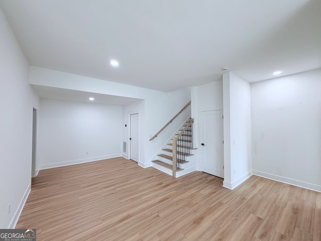 5753 Brendlynn Dr, Suwanee, GA 30024 - finished below grade area featuring light wood-style floors, stairway, and recessed lighting