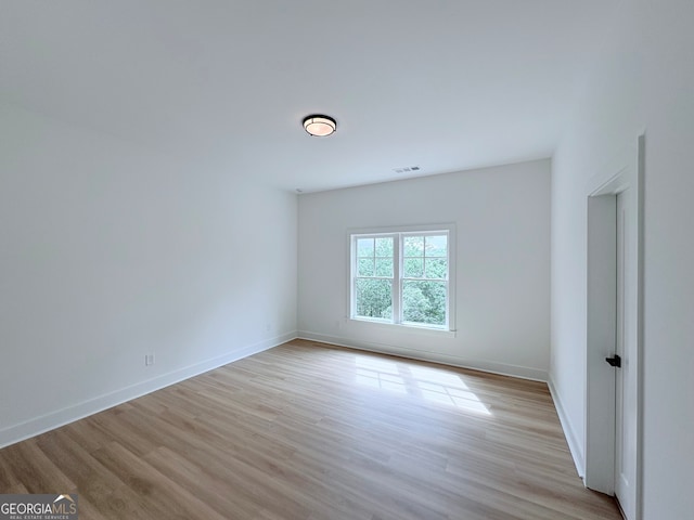 5753 Brendlynn Dr, Suwanee, GA 30024 - empty room with light wood finished floors and baseboards