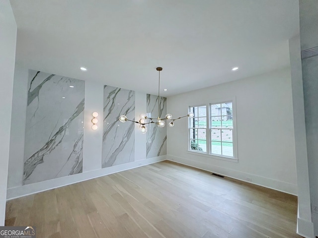 5753 Brendlynn Dr, Suwanee, GA 30024 - unfurnished dining area featuring wood finished floors, recessed lighting, and a chandelier