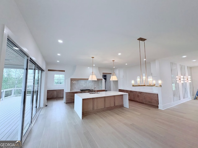 5753 Brendlynn Dr, Suwanee, GA 30024 - kitchen with modern cabinets, light wood-style flooring, tasteful backsplash, recessed lighting, and light countertops