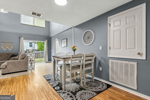 224 Pine Bluff Dr, Kingsland, GA 31548 - dining room with arched walkways, baseboards, visible vents, and wood finished floors