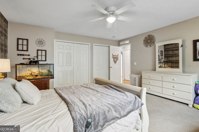 224 Pine Bluff Dr, Kingsland, GA 31548 - carpeted bedroom featuring a ceiling fan and two closets