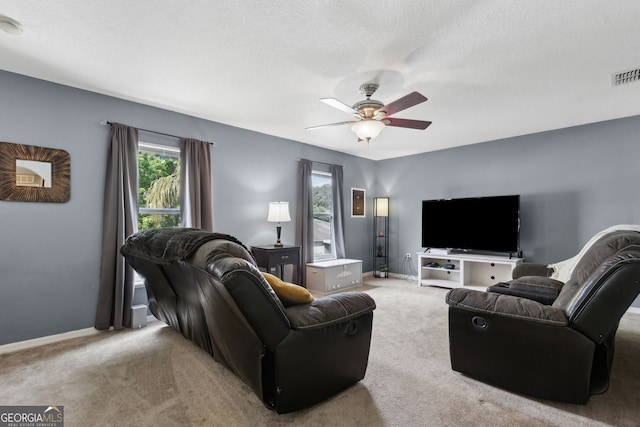 224 Pine Bluff Dr, Kingsland, GA 31548 - carpeted living room with baseboards, a ceiling fan, a textured ceiling, and visible vents