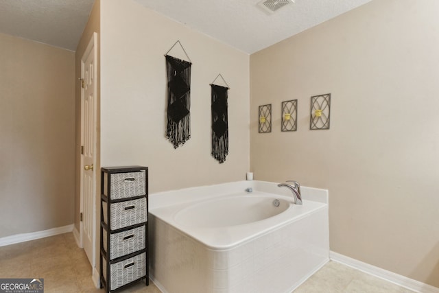 224 Pine Bluff Dr, Kingsland, GA 31548 - bathroom with tile patterned floors, visible vents, baseboards, and a bath