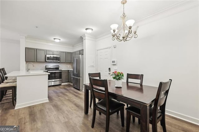 5559 Glenridge Dr Unit 1103, Sandy Springs, GA 30342 - dining area with baseboards, ornamental molding, wood finished floors, and a chandelier