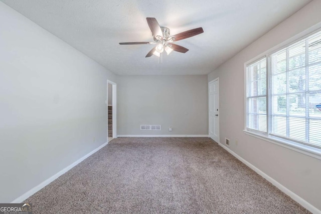 8431 Magnolia Dr, Jonesboro, GA 30238 - unfurnished room with baseboards, ceiling fan, carpet flooring, and visible vents