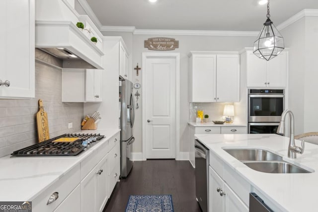4207 N Carver Dr, Atlanta, GA 30360 - kitchen with stainless steel appliances, custom range hood, white cabinetry, backsplash, and decorative light fixtures