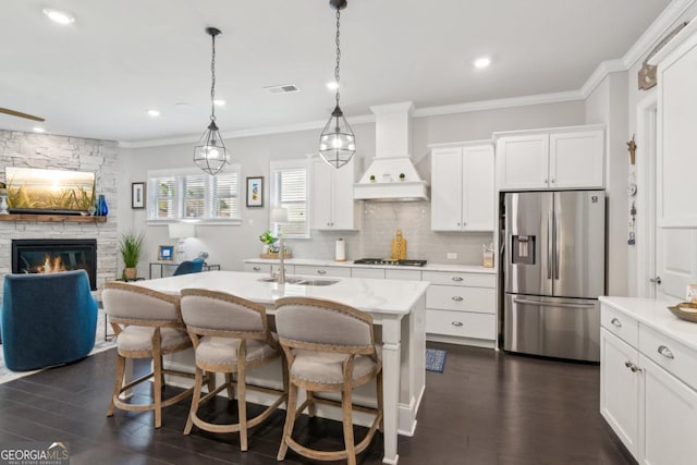 4207 N Carver Dr, Atlanta, GA 30360 - kitchen with visible vents, light countertops, a sink, custom exhaust hood, and stainless steel fridge
