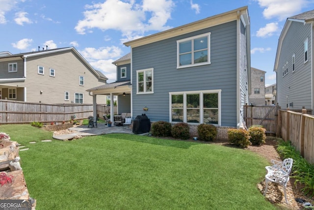 4207 N Carver Dr, Atlanta, GA 30360 - back of house with a lawn, a ceiling fan, a fenced backyard, and a patio area
