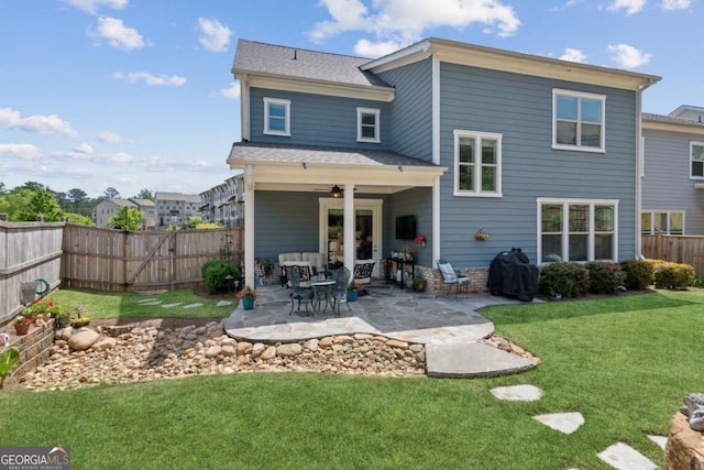 4207 N Carver Dr, Atlanta, GA 30360 - rear view of property with a fenced backyard, a ceiling fan, a yard, and a patio area