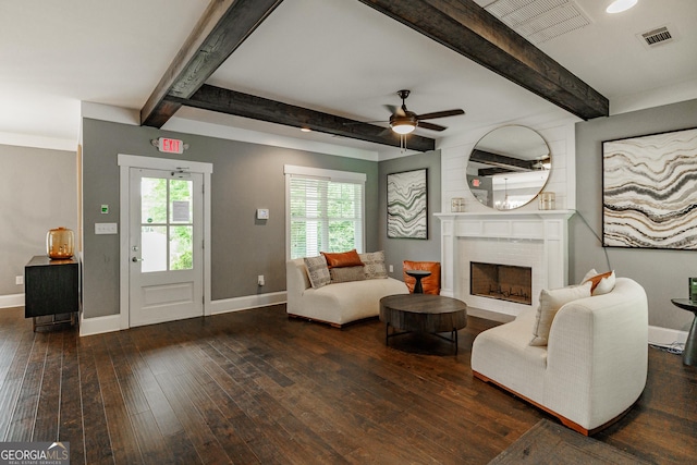 living room featuring baseboards, hardwood / wood-style floors, beam ceiling, and a ceiling fan