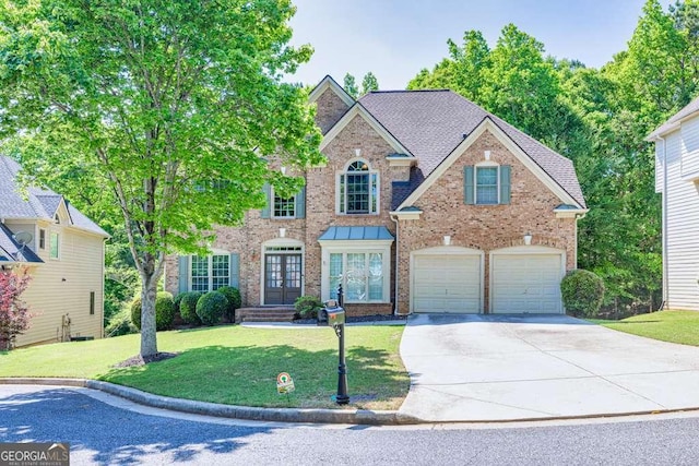 view of front of property featuring an attached garage, a front lawn, brick siding, concrete driveway, and french doors