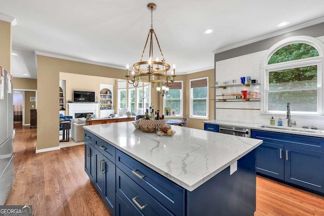 902 Preserve Bluff Dr, Buford, GA 30518 - kitchen with an inviting chandelier, ornamental molding, a sink, and blue cabinets