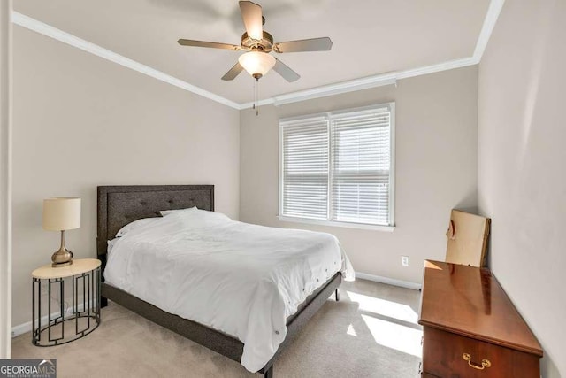 bedroom with baseboards, carpet flooring, crown molding, and a ceiling fan