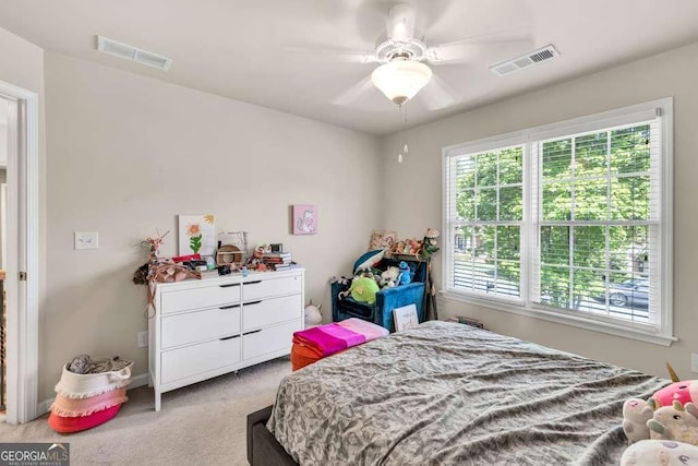 bedroom featuring light colored carpet, ceiling fan, and visible vents