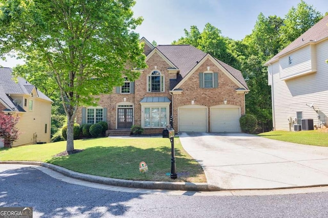 view of front facade featuring a front lawn, cooling unit, french doors, brick siding, and driveway