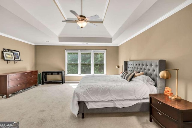 bedroom featuring carpet floors, ornamental molding, a raised ceiling, and ceiling fan
