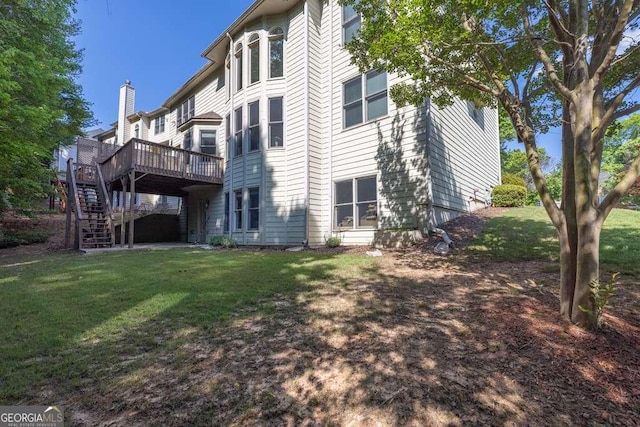 rear view of property with stairs, a wooden deck, and a yard
