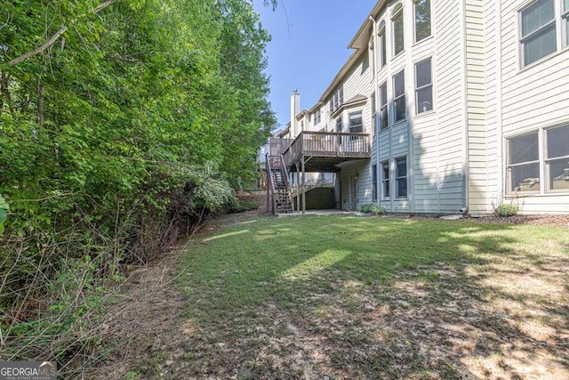 view of yard featuring a wooden deck and stairway
